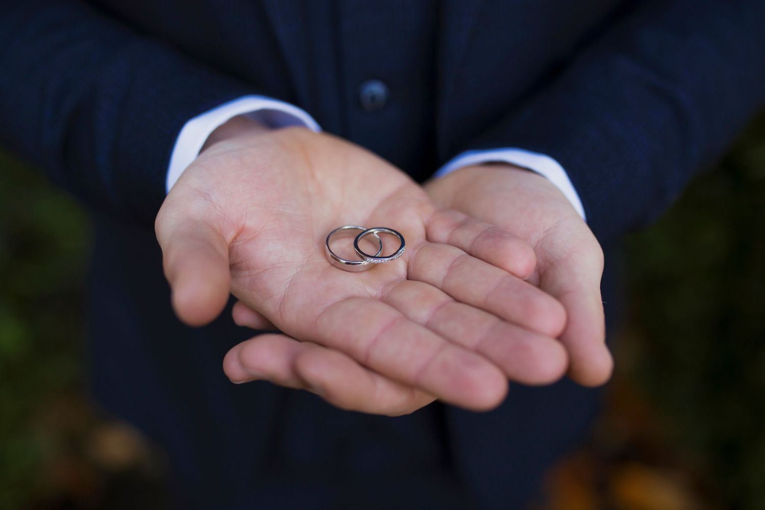 Wedding rings in grooms hand
