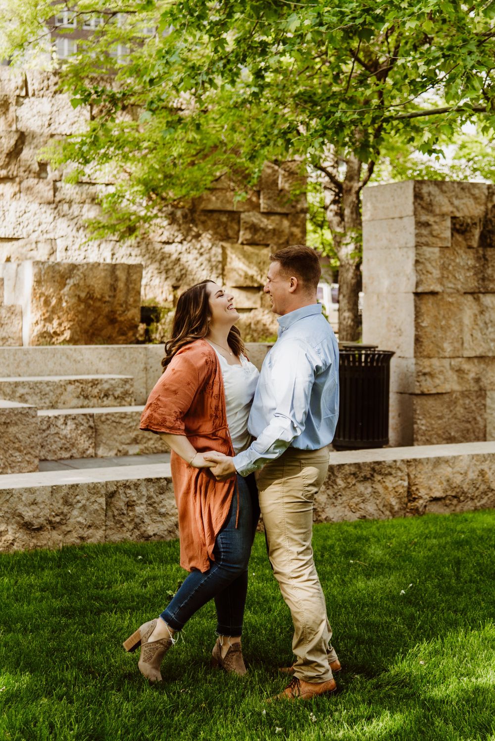 Dancing sequence captured on green lawn with stone wall backdrop.