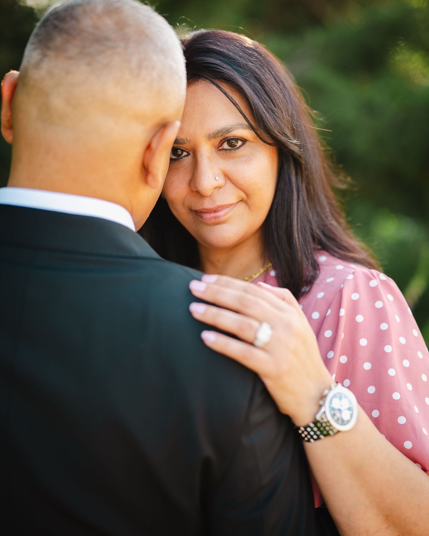 Romantic engagement photo session featuring a couple in a pink polka dot dress and suit.