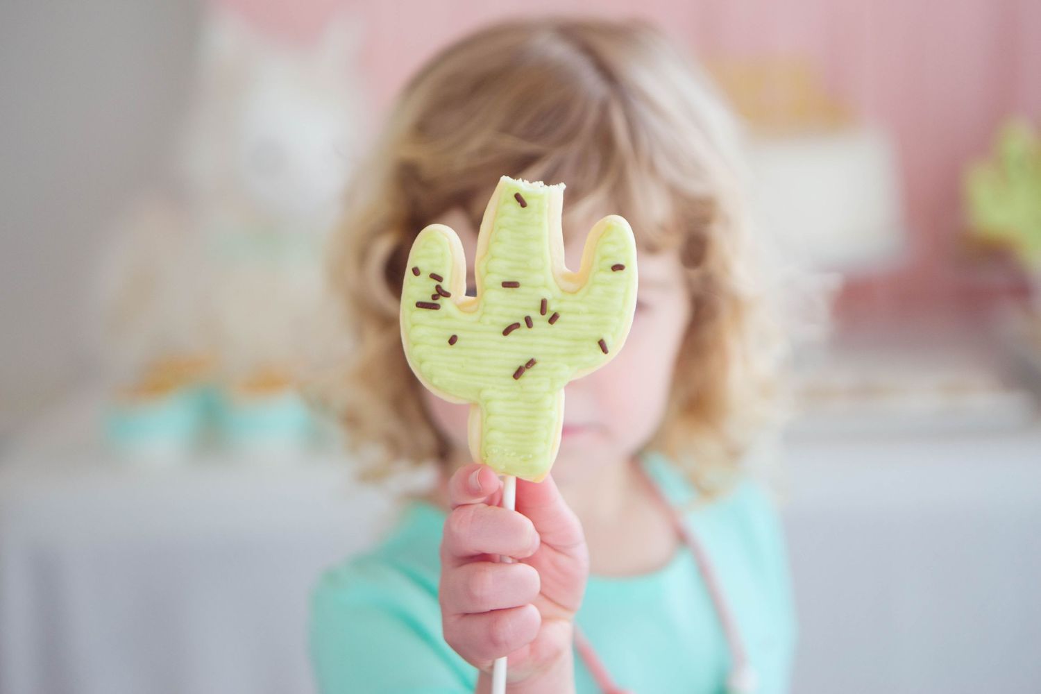 Surrey BC Vancouver Event Photographer Little girl holding up cactus shaped cookies