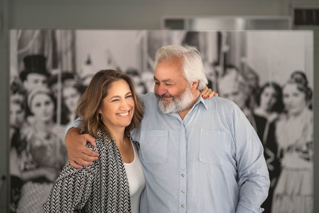 Happy couple sharing a candid moment against black and white background.