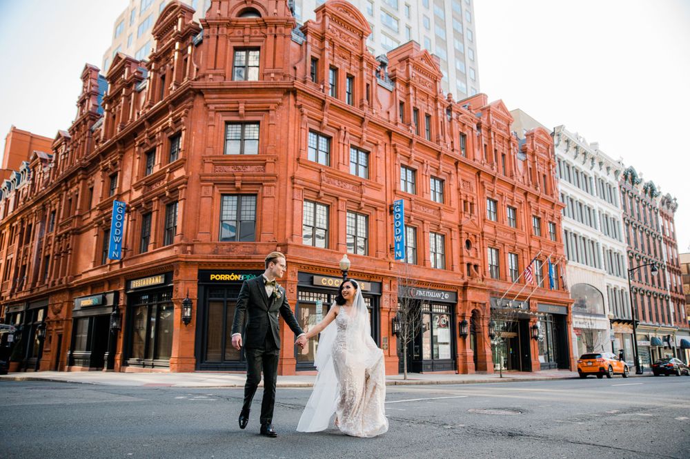 bride and groom crossing the street in front of the Goodwin Hotel in Hartford, CT