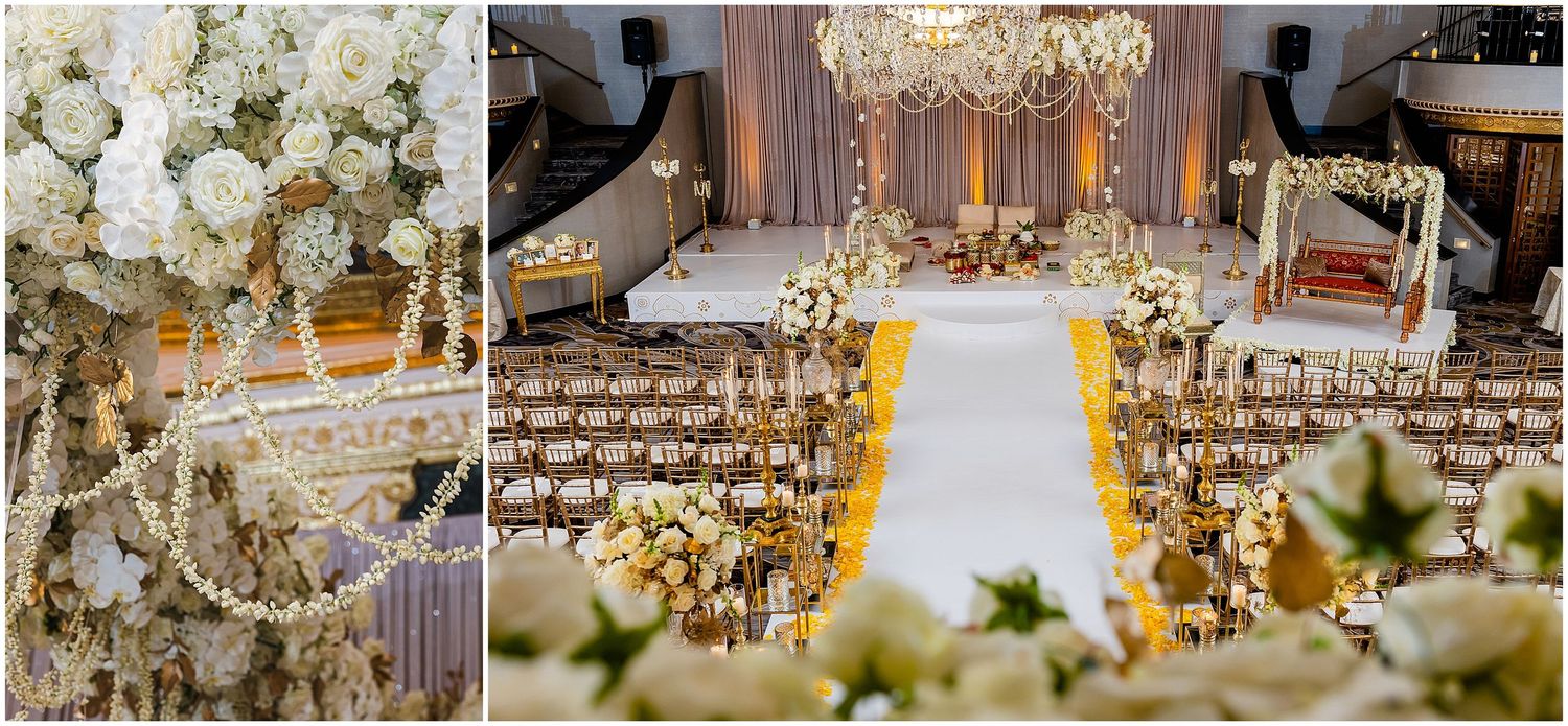 Ornate wedding ceremony space with white floral arrangements and a white aisle runner under chandeliers.