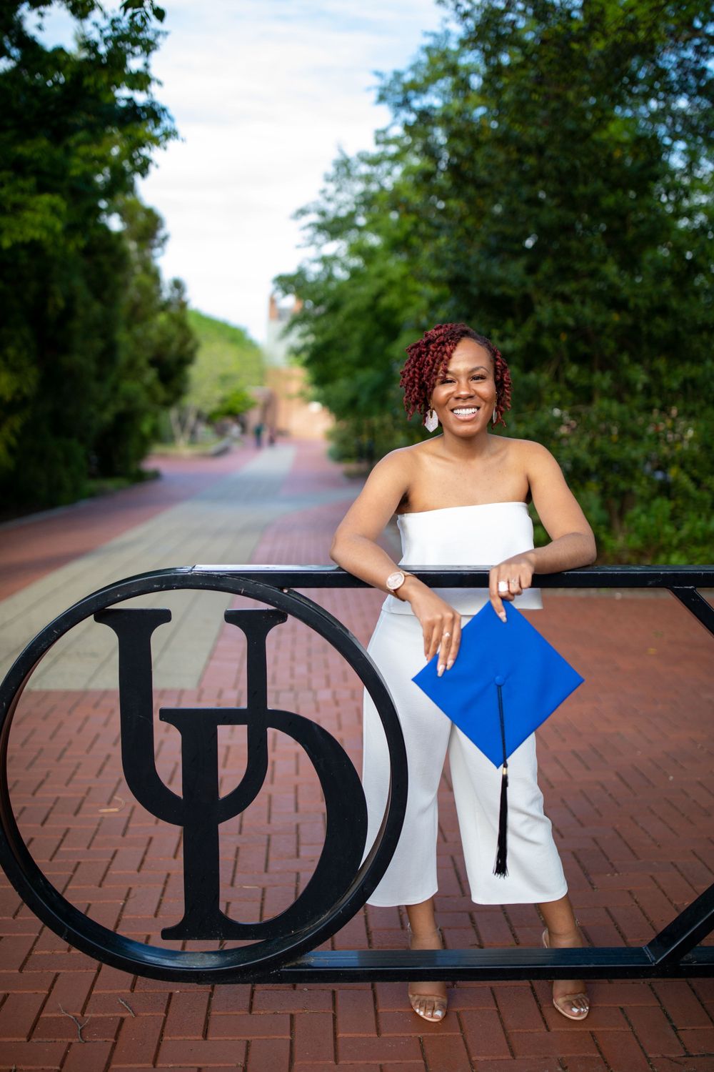 Close-up of graduation tassel and medallion against blue gown.