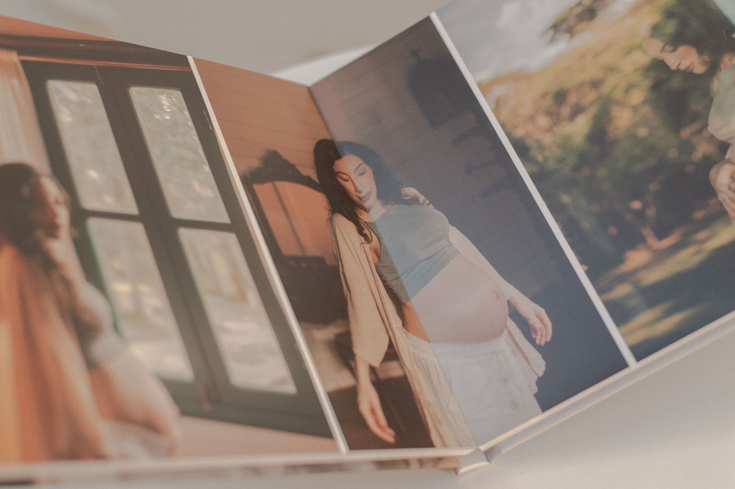 Artistic photo book spread showing lifestyle portraits in warm tones.