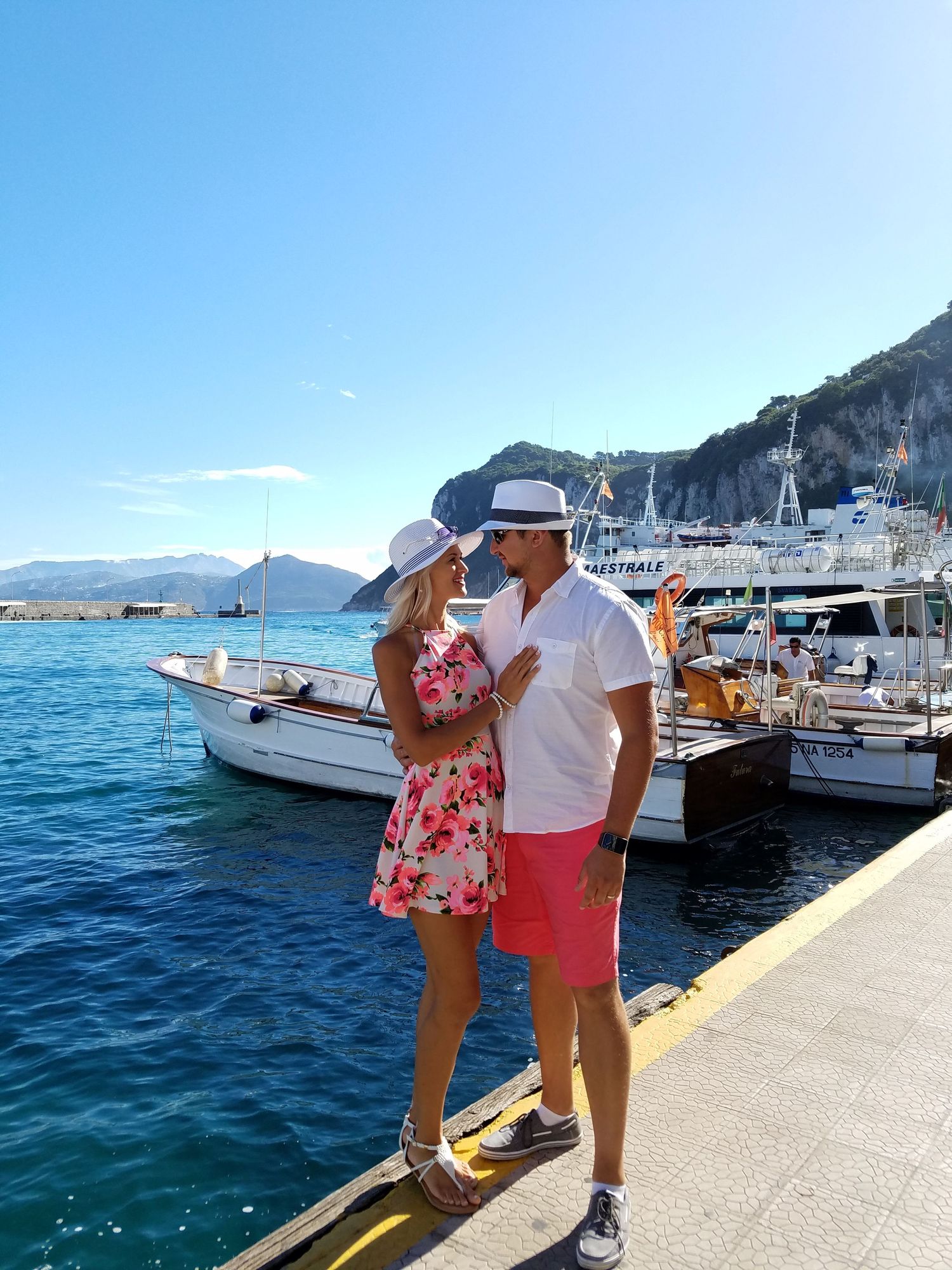 photo of couple near the ocean harbor