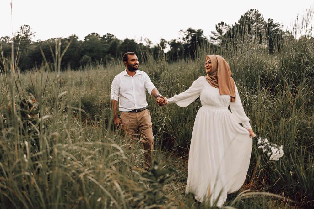 Indian woman leading her husband through field