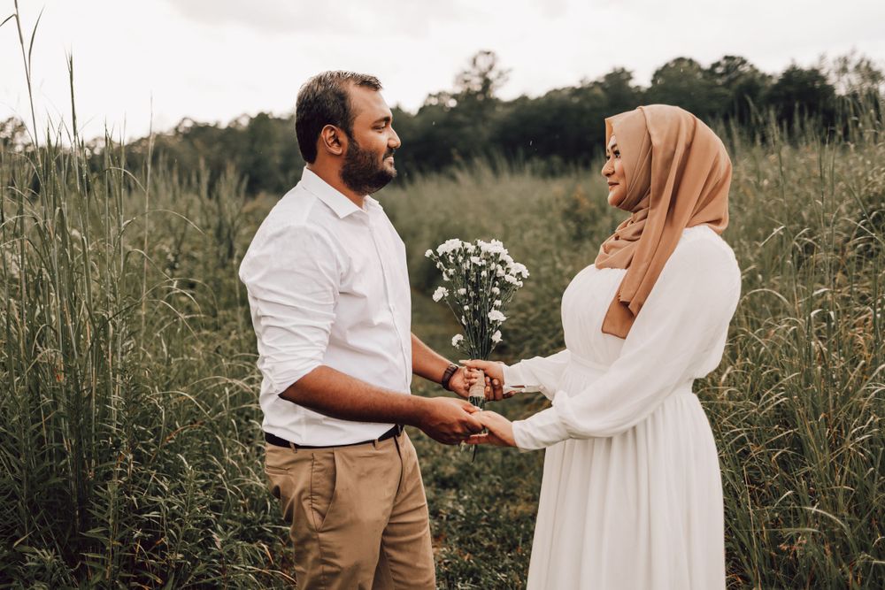 Indian couple facing each other in field
