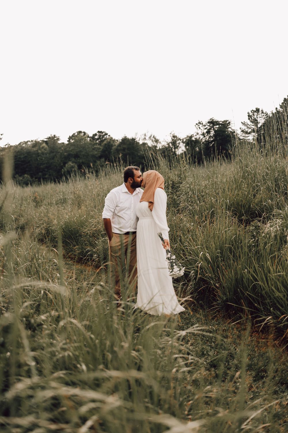 Indian couple kissing in field