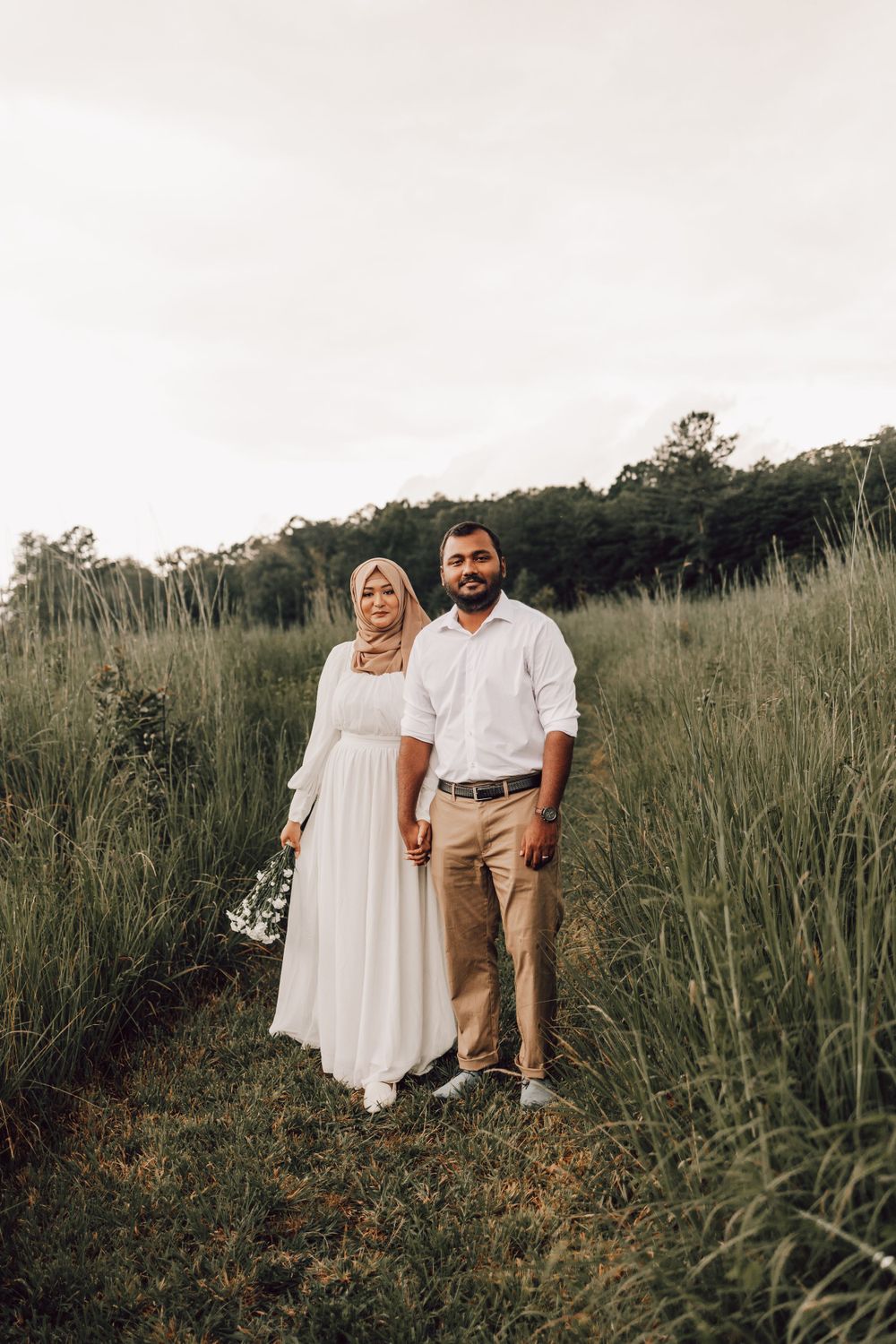 Indian couple standing in field