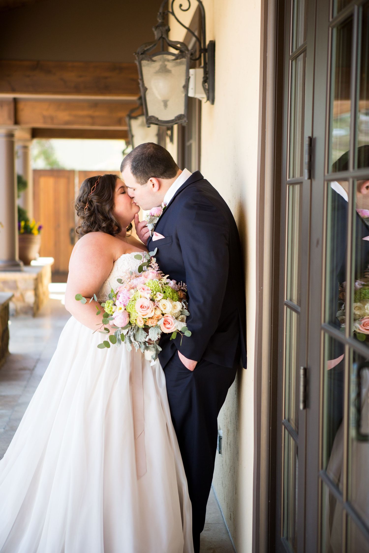 A tender moment captured under a rustic porch light fixture.