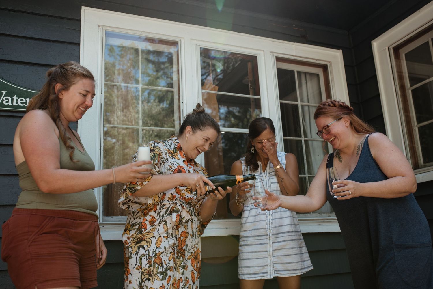 Friends gathered on a porch sharing laughs and snacks during a casual get-together.