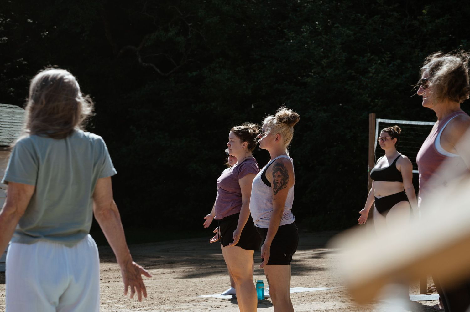A candid outdoor summer gathering captured in natural sunlight.