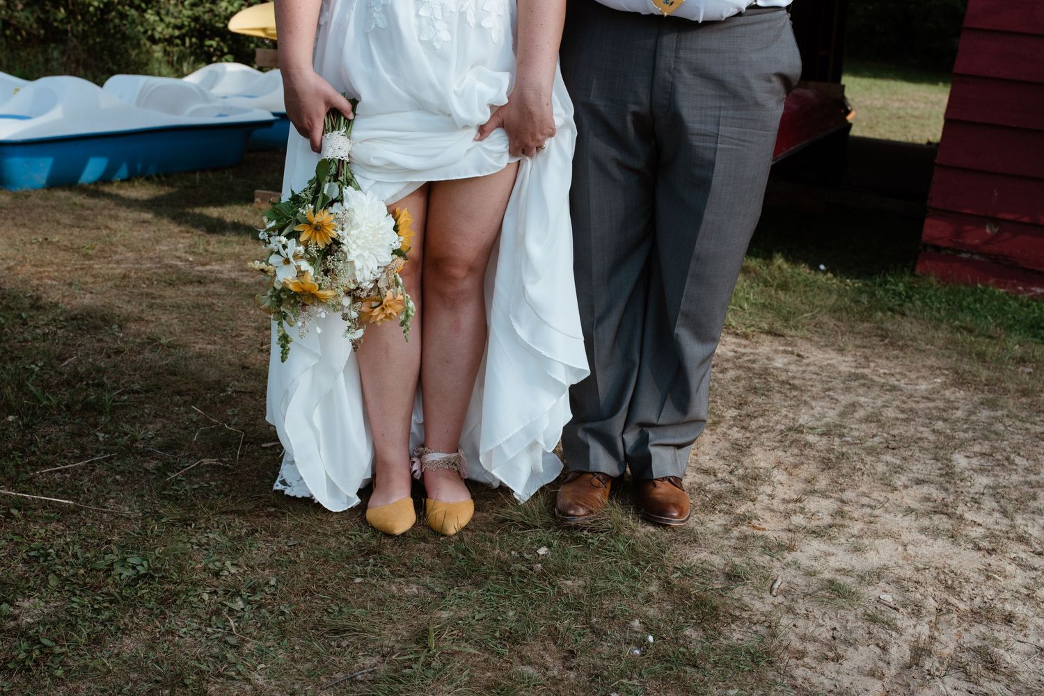 Wedding party members showing their shoes and dress details outdoors on a summer day.