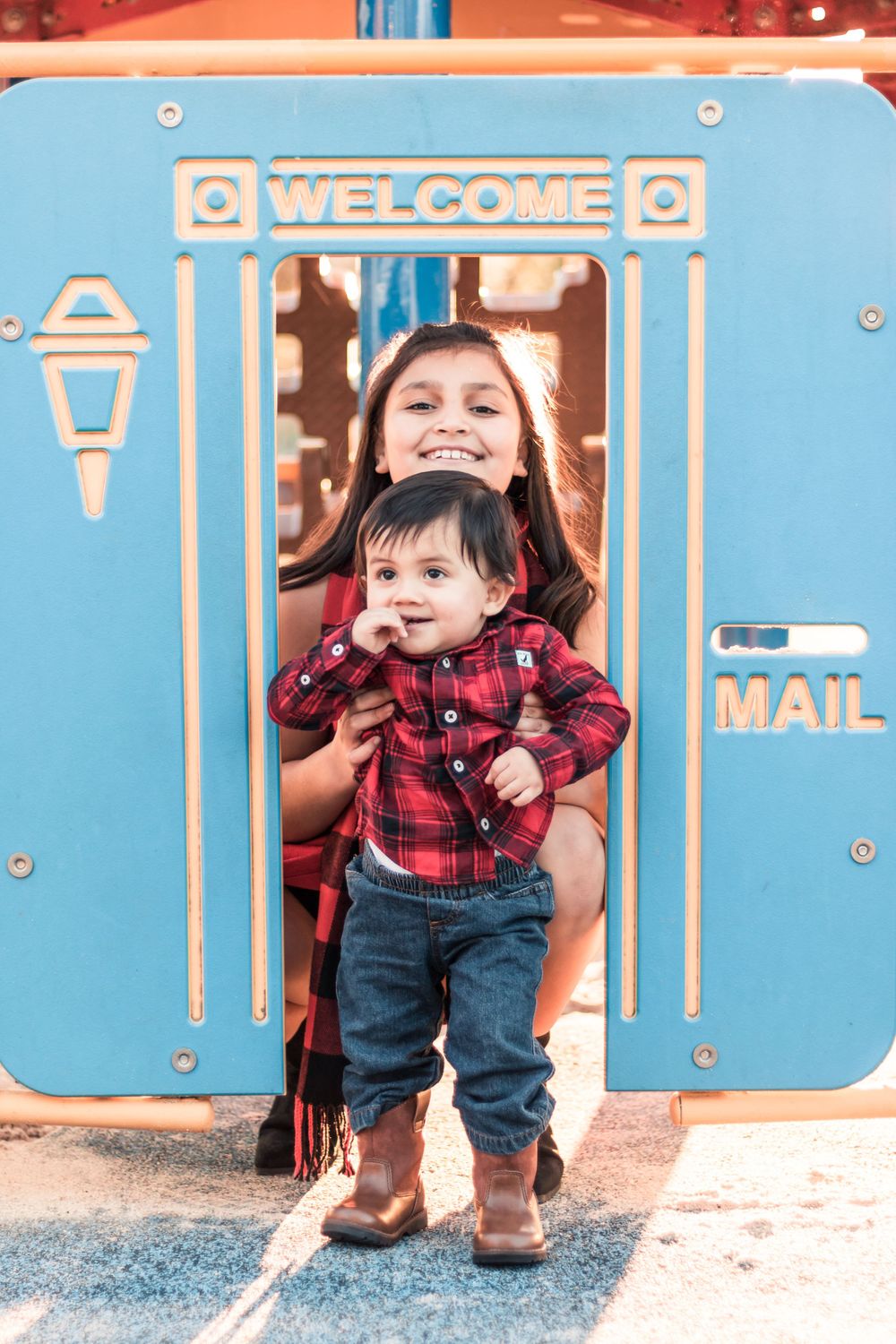 Cute Family Photography in a playground in Fresno, California Siblings Playing