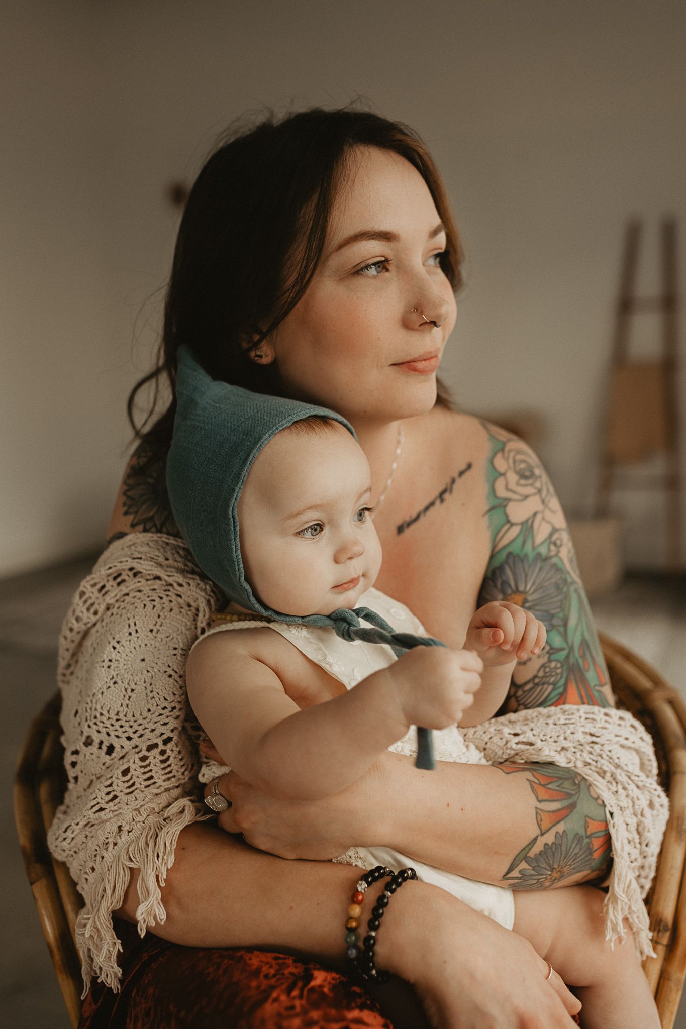 Tender mother and me moment in warm natural light showing tattoo detail during mother and me photo session.
