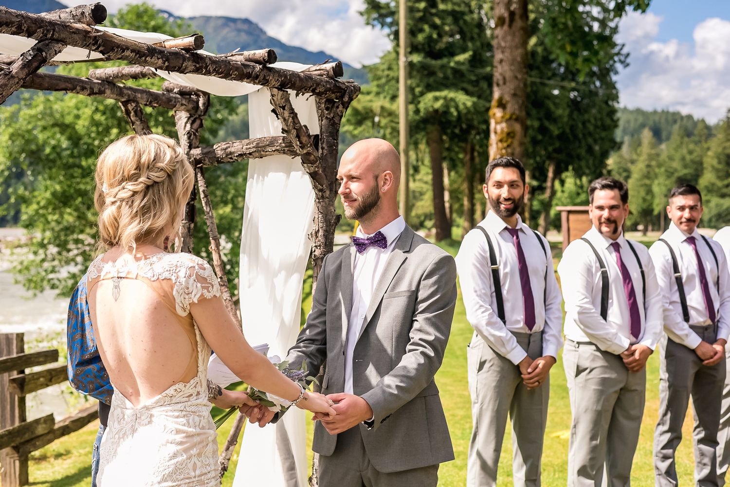 Bride and groom hold hand during ceremony. Photo taken by Kari Mills Photography, Vancouver wedding photographer.