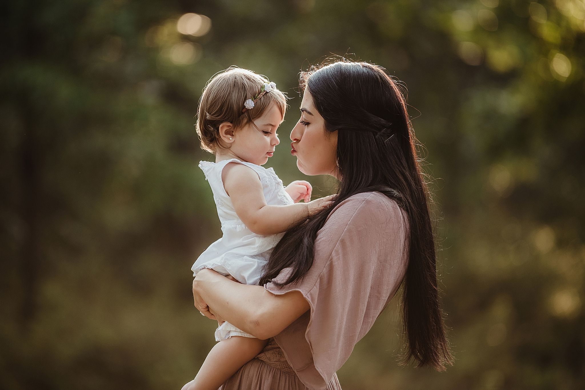 An intimate portrait of affection captured in warm evening light outdoors.
