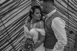 Intimate black and white wedding photos with geometric bamboo wall patterns.