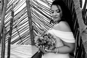 Monochrome bridal portrait with natural light filtering through bamboo.