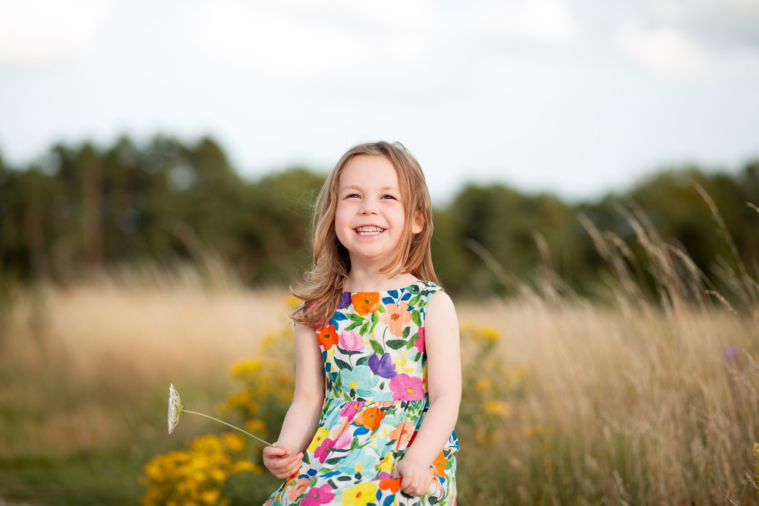 Portrait session in a dreamy wildflower field during summer.