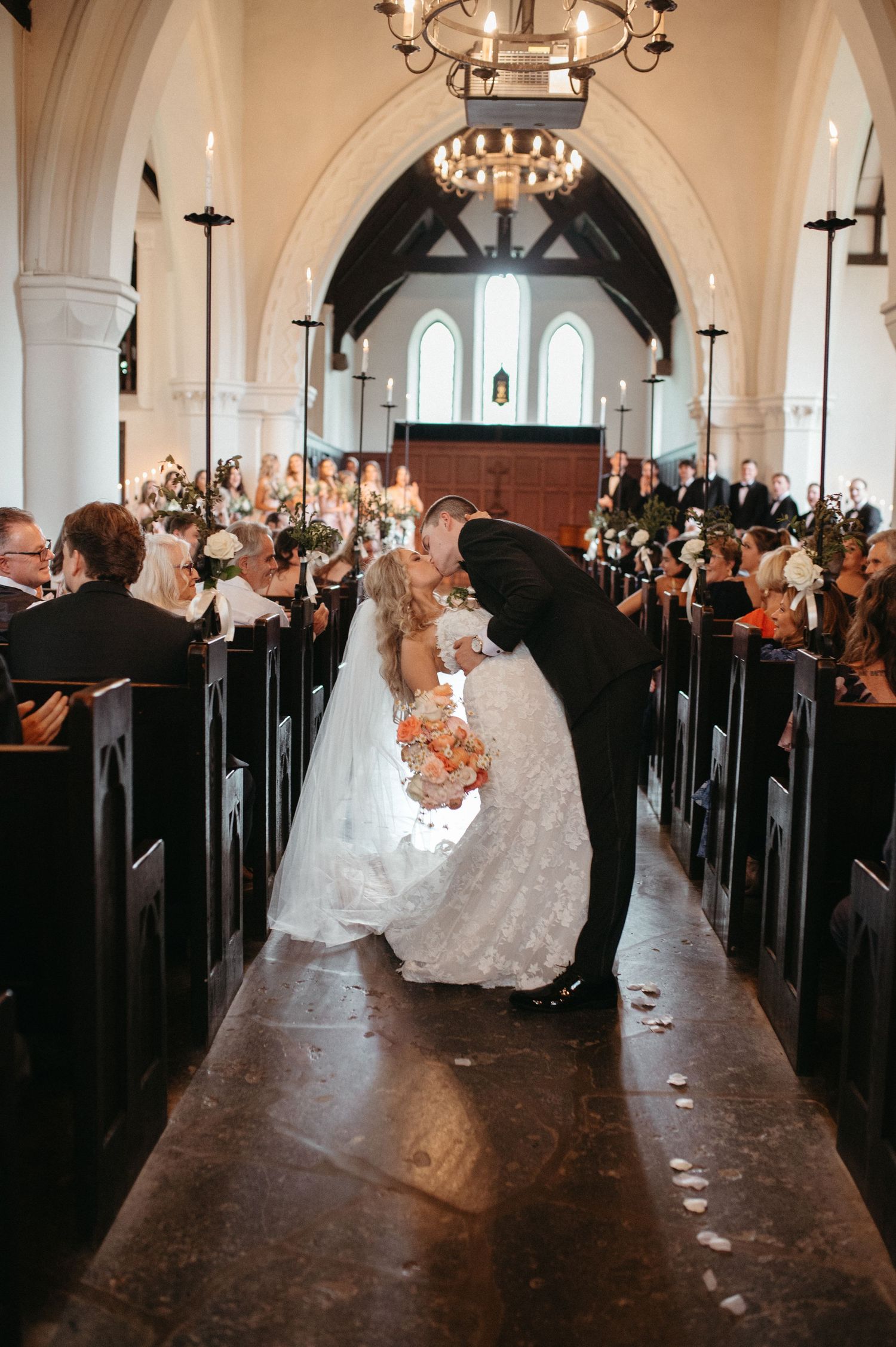 Church wedding ceremony with floral decorations in a traditional chapel setting.
