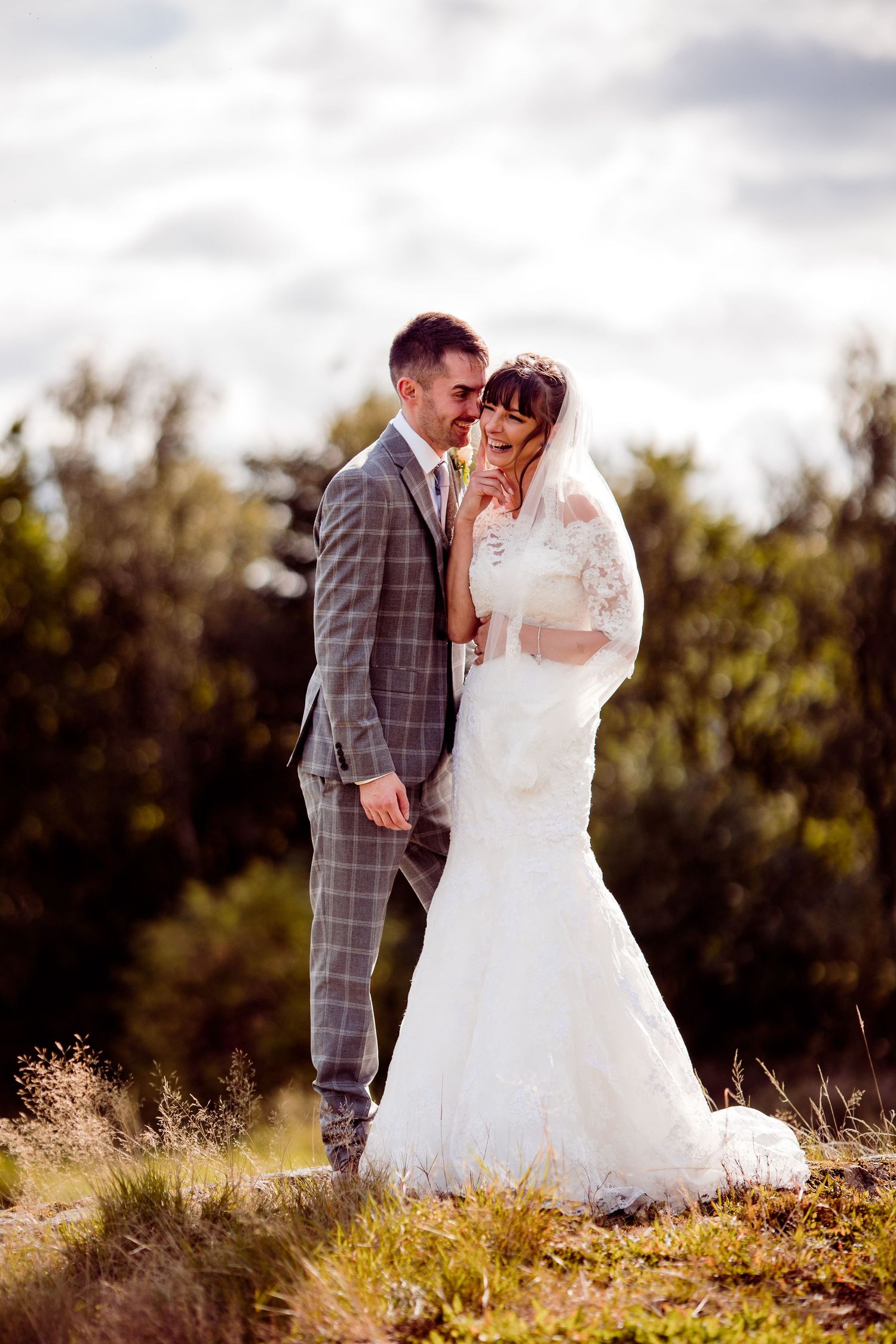 Bride and groom laughing at Carus Green Golf Club