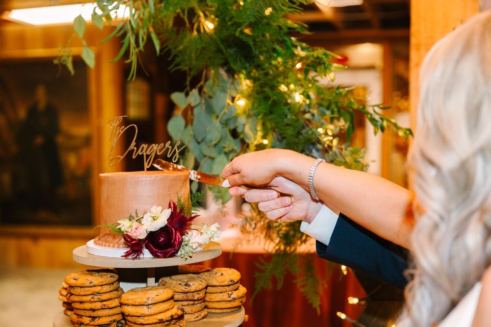 Wedding dessert display with cookies and floral decorations.