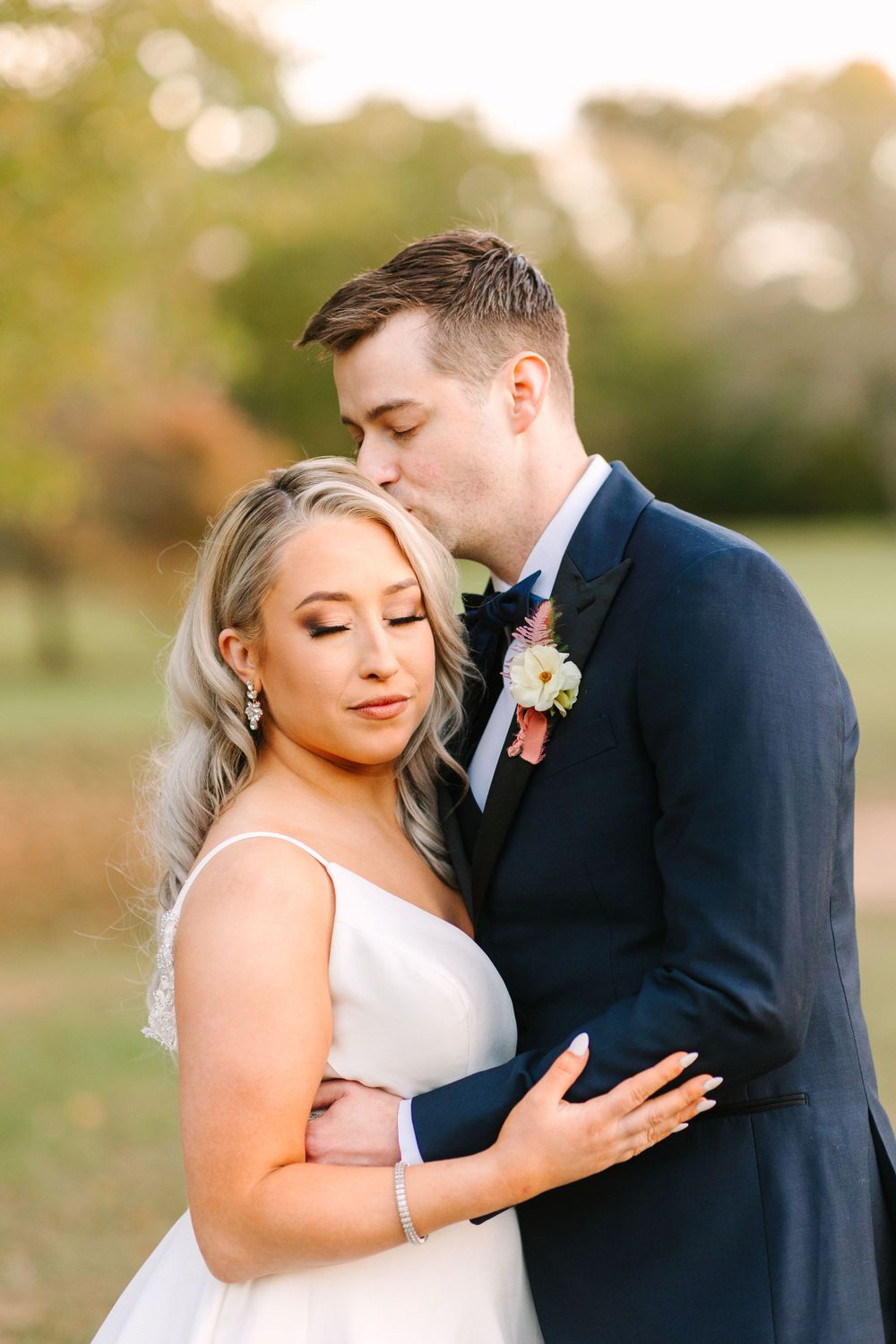 Intimate wedding portrait during golden hour with soft romantic lighting.