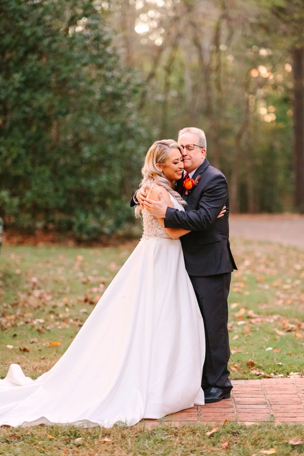 An emotional embrace between loved ones during an outdoor autumn wedding photo session.