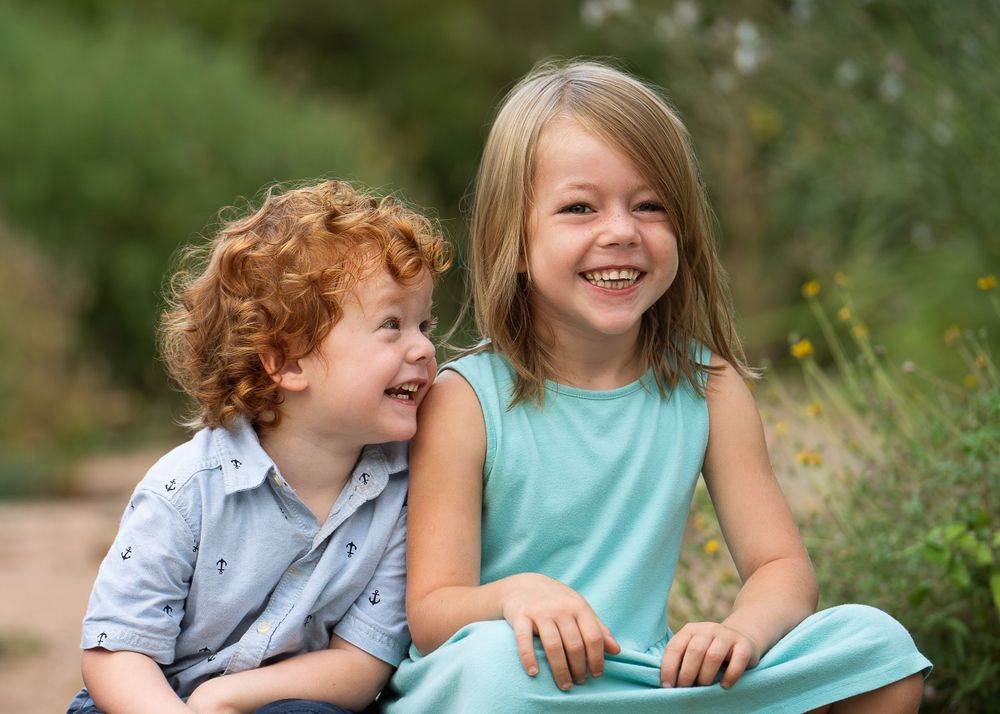brother and sister sitting on steps of Landa Gardens at Landa Library in San Antonio Texas