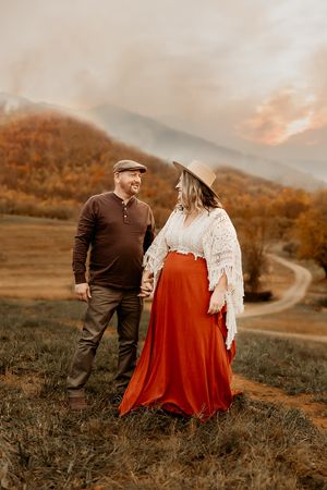 A couple stand in the Shenandoah during their Fall photo session.
