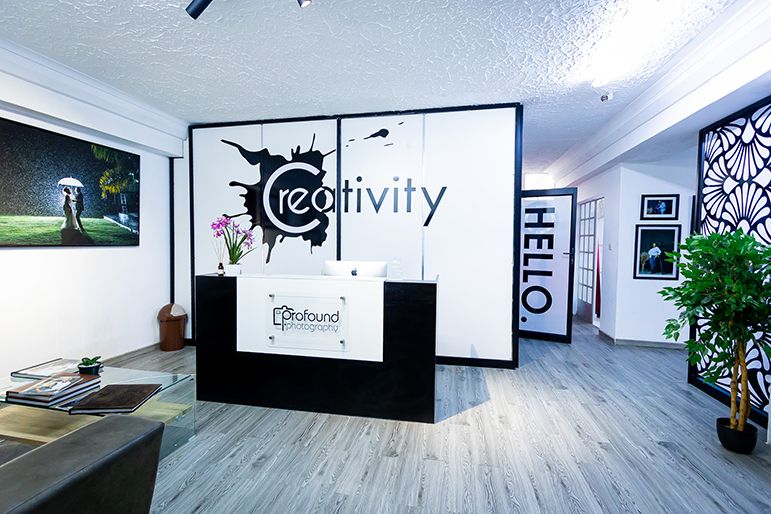 Modern office reception area with creative branding and minimalist black and white design.