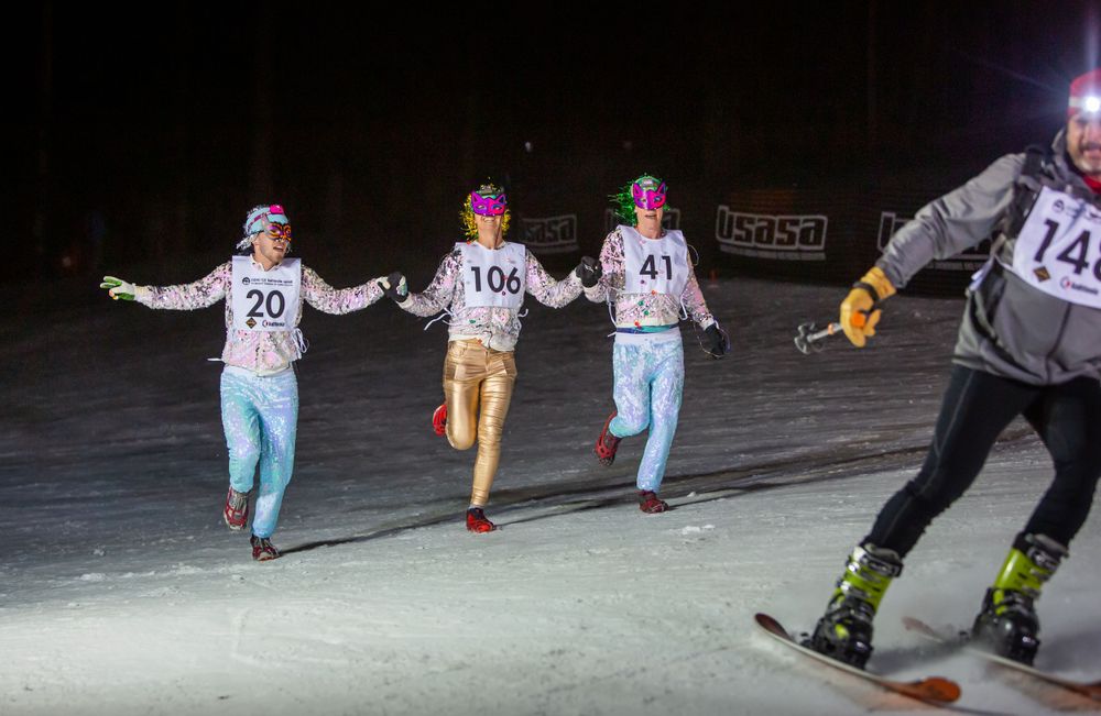 Four participants crossing the finish line of the 2020 GORE-TEX Kahtoola Uphill.