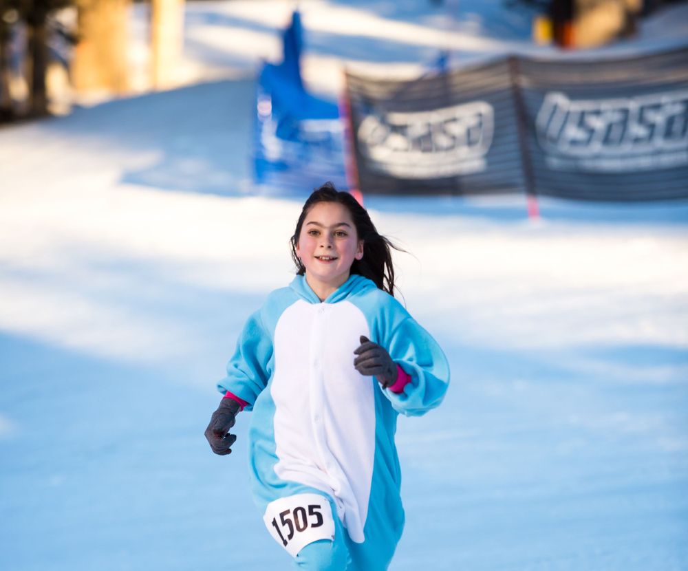 A runner in a blue and white onesie finishes the 2020 GORE-TEX Kahtoola Uphill.