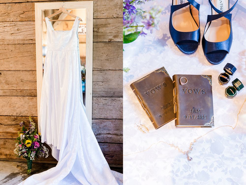 Wedding dress hanging with navy blue shoes and vintage books styled on rustic wood background.