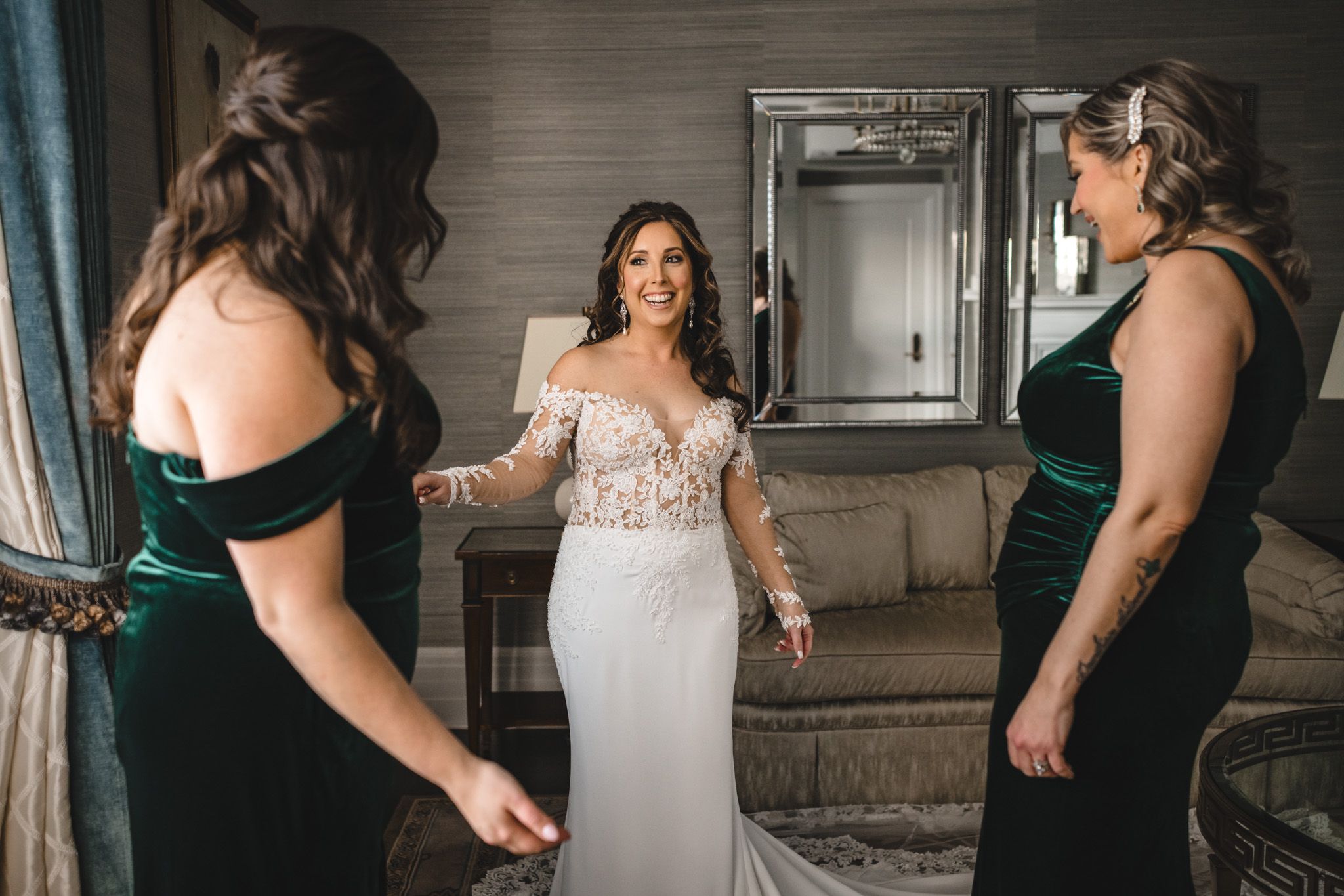 Candid moments of wedding preparation with bridesmaids in emerald dresses.