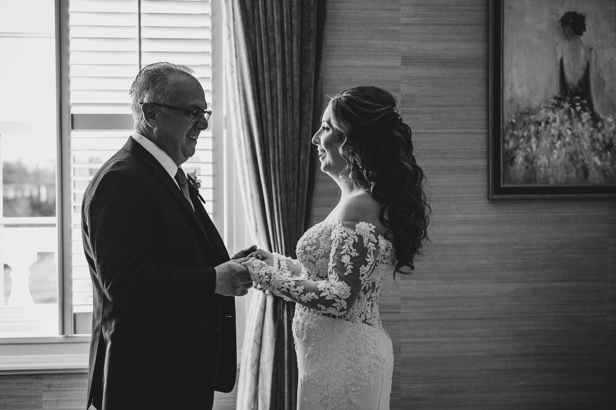 Emotional wedding day first look between a couple in formal attire sharing an intimate moment.