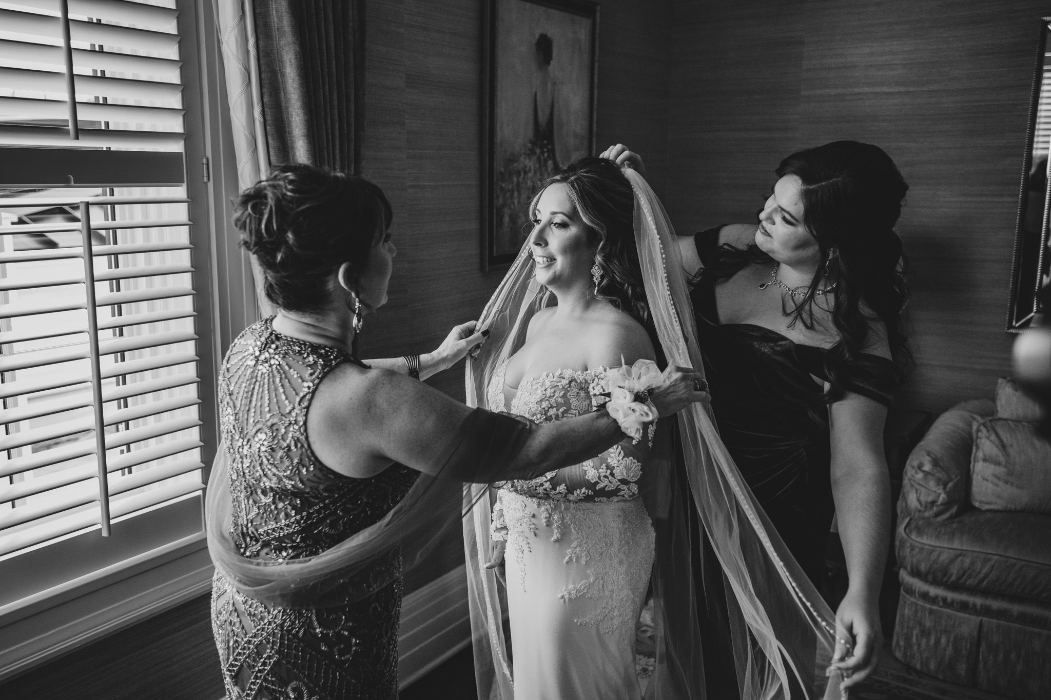 Behind-the-scenes moment of wedding day preparations in a room with natural lighting.