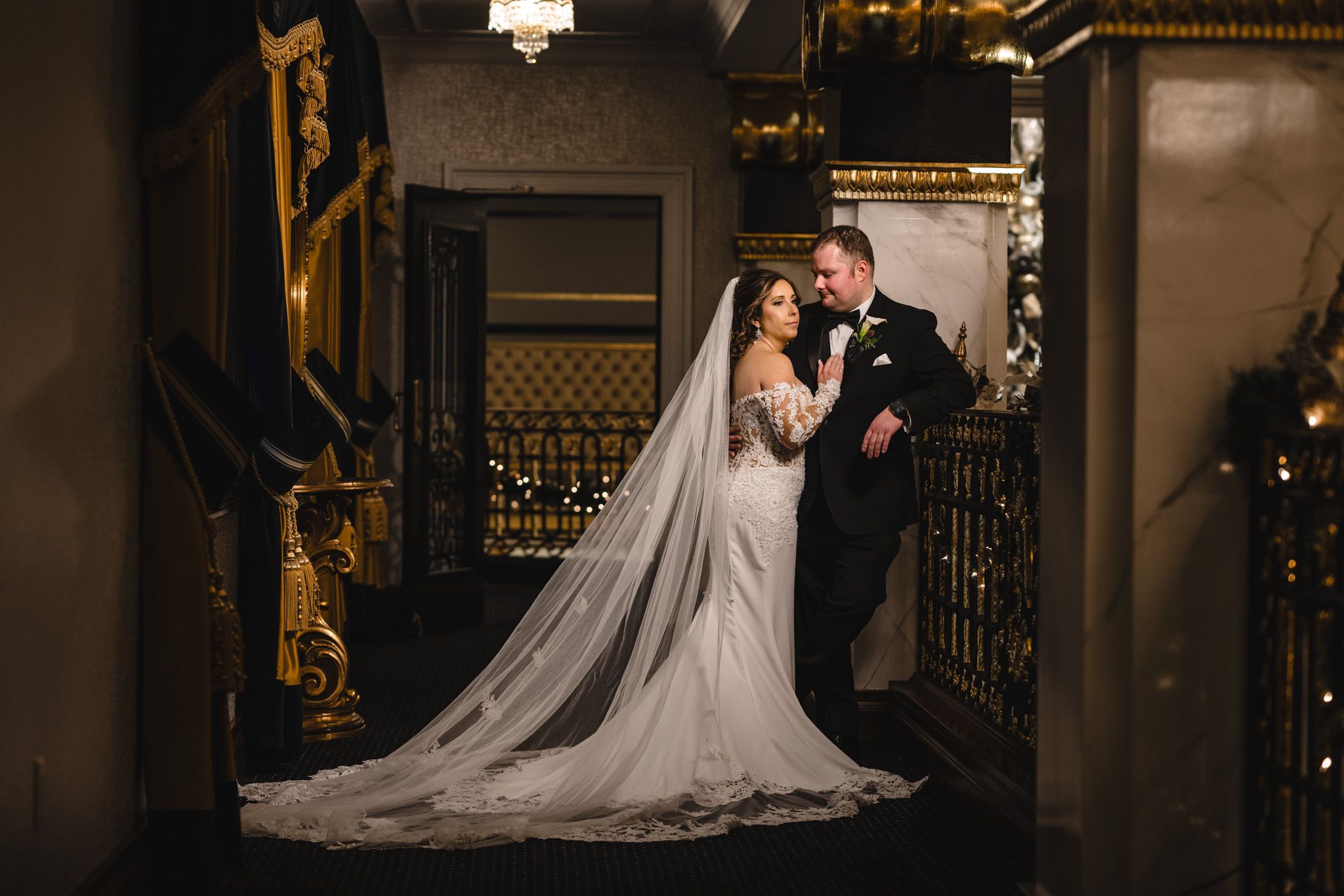 Romantic wedding moments photographed in an elegant indoor setting with warm lighting.