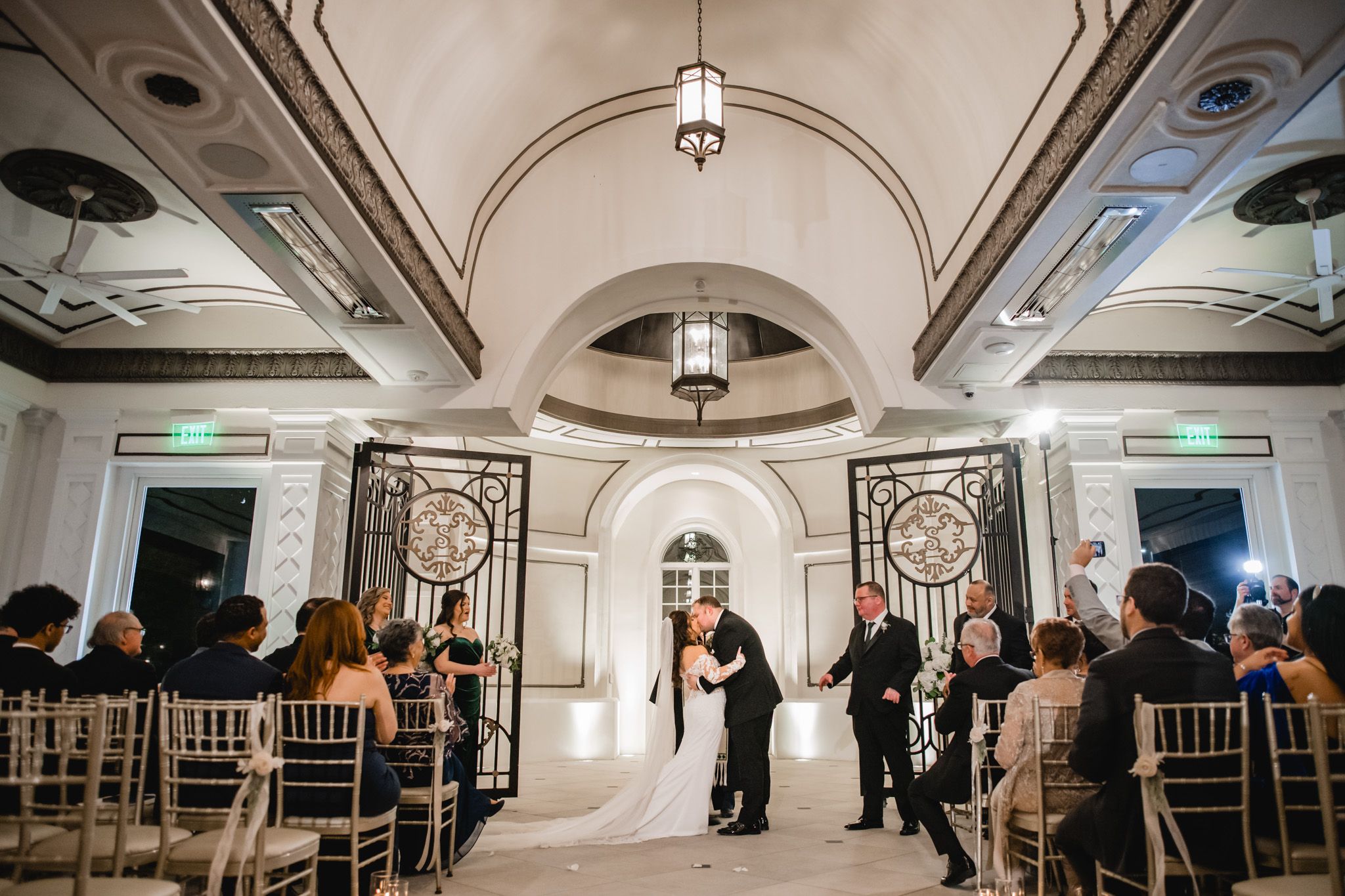 Panoramic view of an elegant wedding venue with vaulted ceilings and classic architectural details.