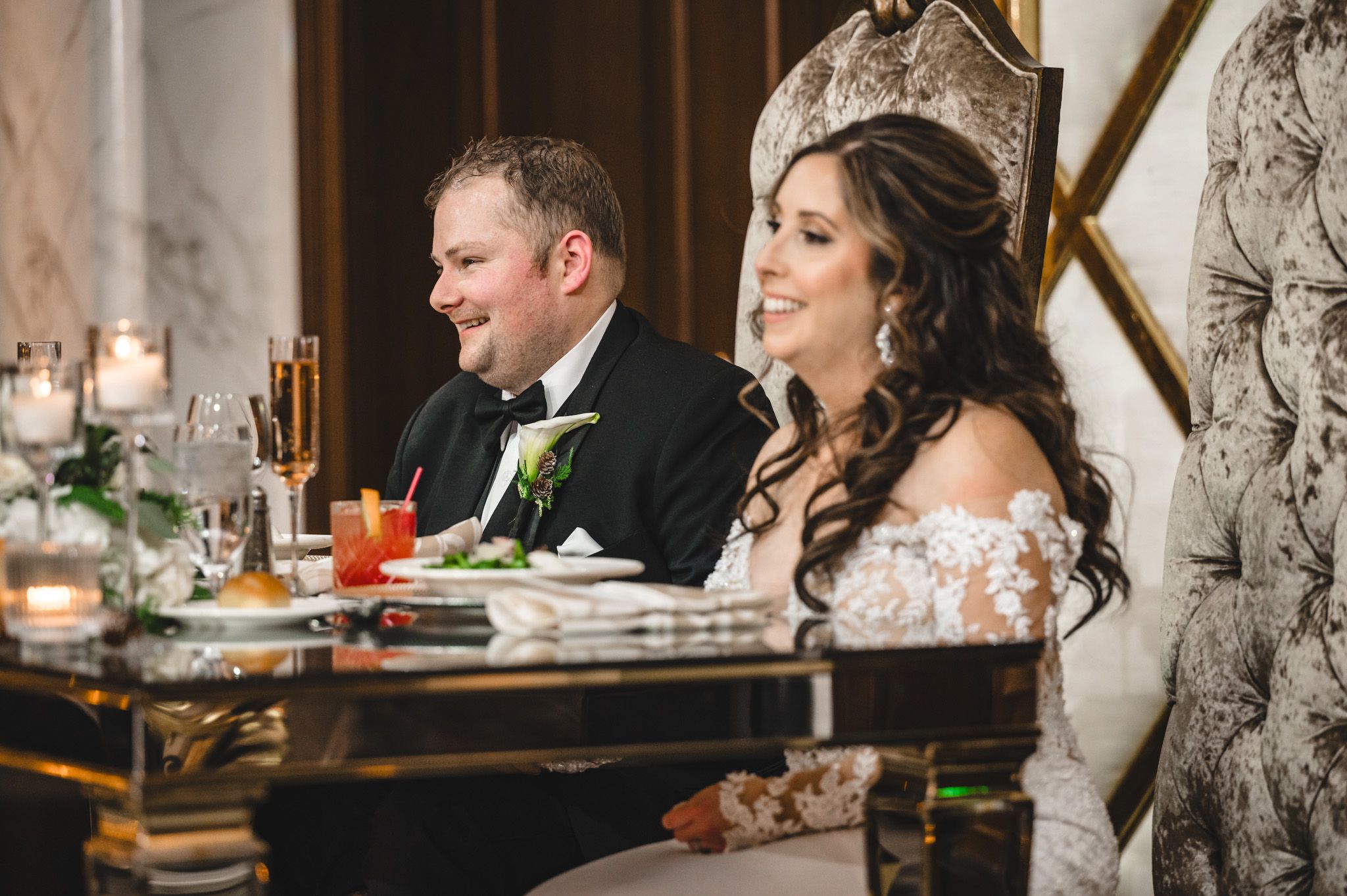 Wedding couple shares intimate moments at an elegantly decorated reception table.