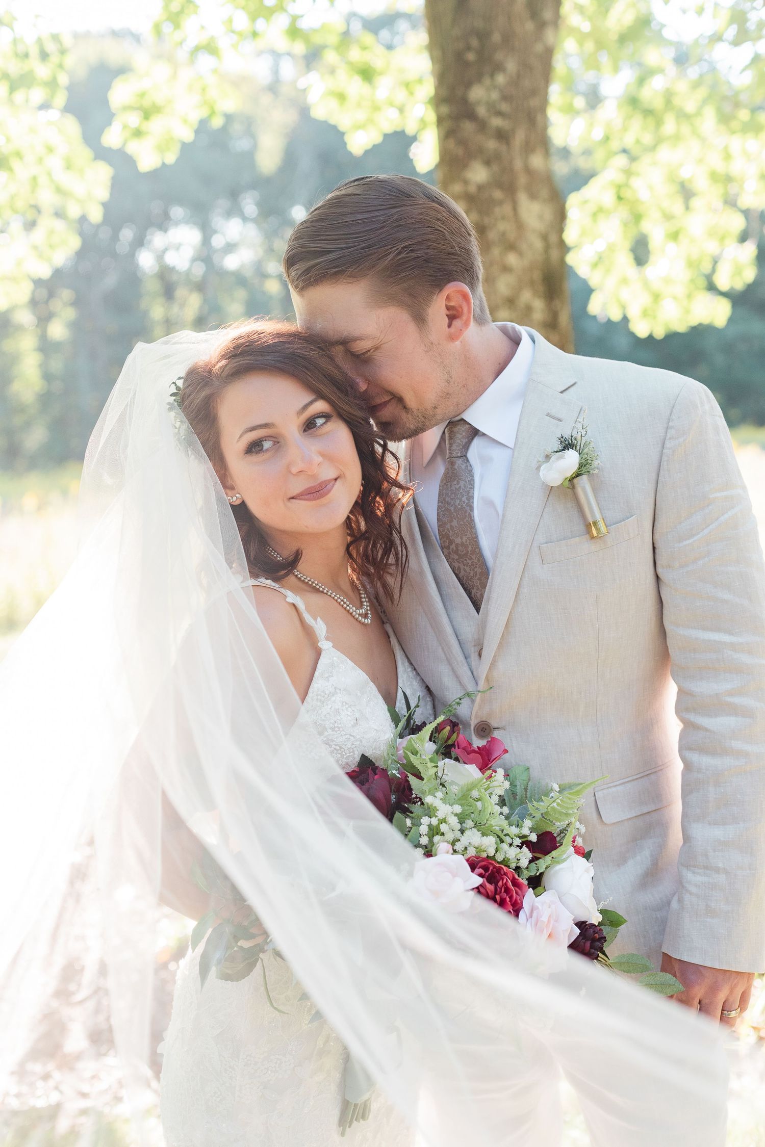 Elegant wedding portraits showcase tender moments between newlyweds against a bright natural backdrop.