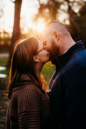 Intimate sunset portrait of a couple sharing a tender moment during their engagement session.