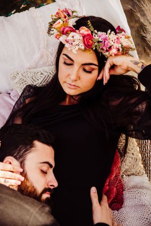 Intimate moment captured with floral crown and soft textured fabrics.