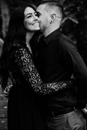 Intimate black and white portrait of a couple in elegant evening wear.