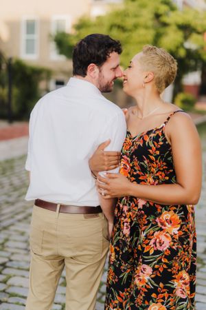 Joyful couple laughing together during outdoor portrait session.