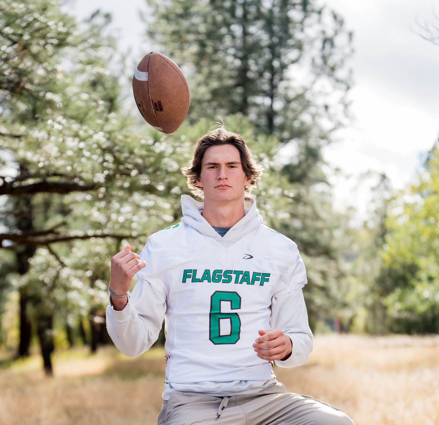 Jake Weidinger tosses a football for Flagstaff photographer, Sean Openshaw, for his 2022 senior photos.