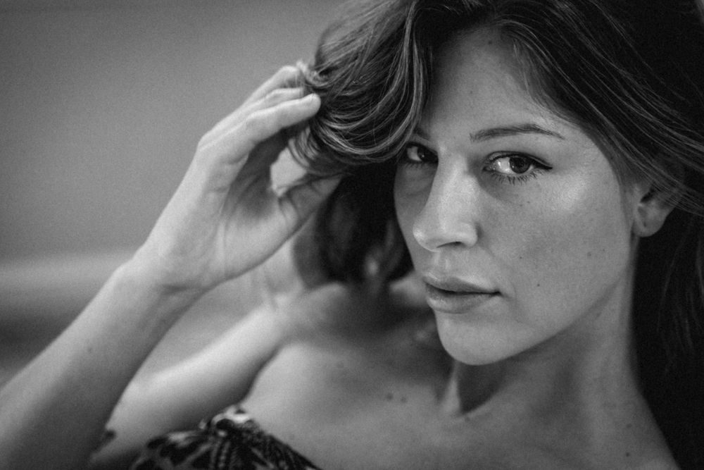 Dramatic black and white close-up portrait with soft side lighting.