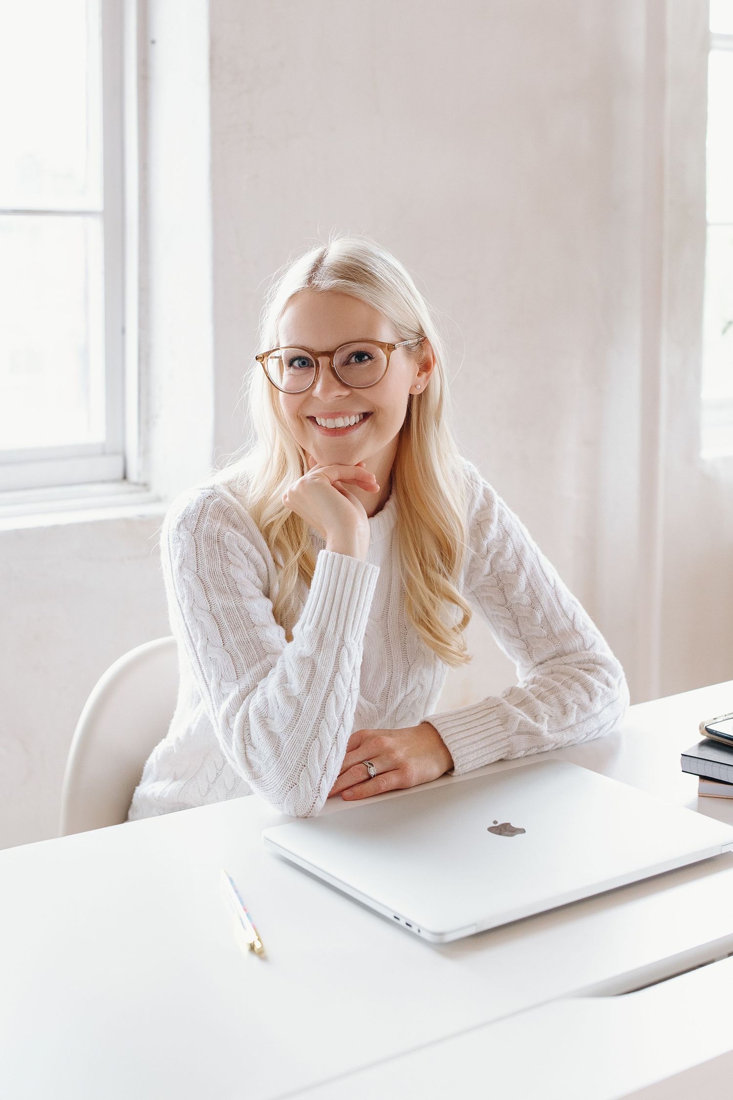 Jackie Orlando headshot - at desk, smiling happily